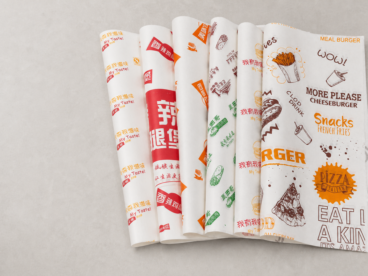 Assortment of custom printed greaseproof paper sheets in different colors and patterns