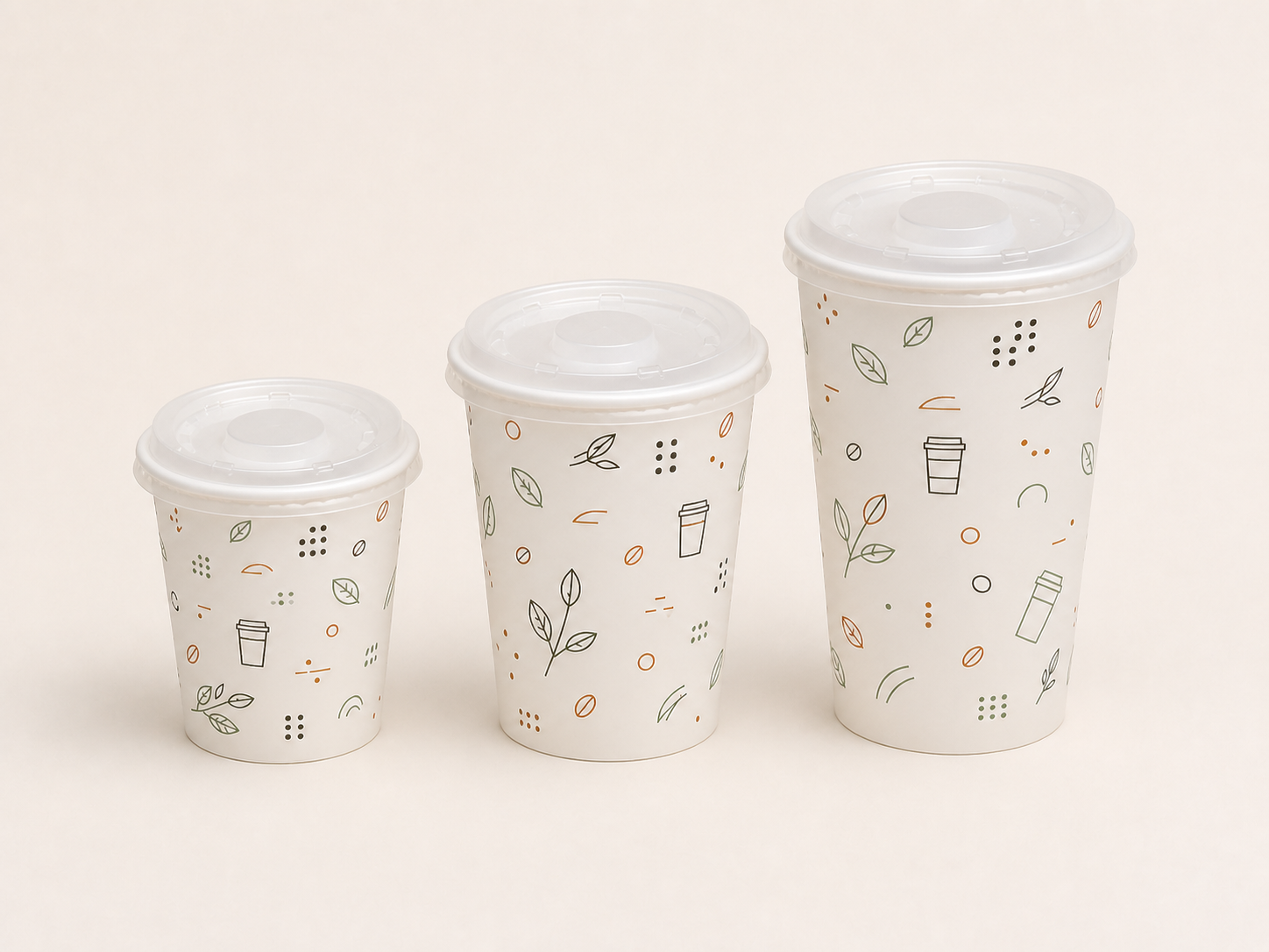 Three sizes of printed paper cups fitted with clear lids